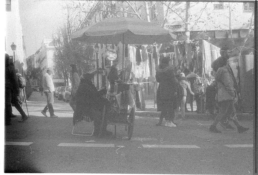 A stall under an umbrella on a winter Sunday at El Rastro de Madrid